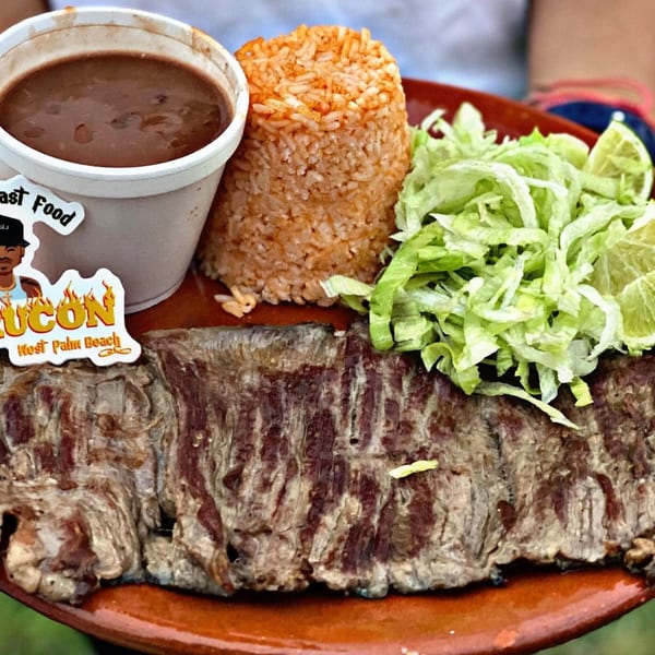 El Rucon's Mexican dish with skirt steak, rice, beans, shredded lettuce, and lime.