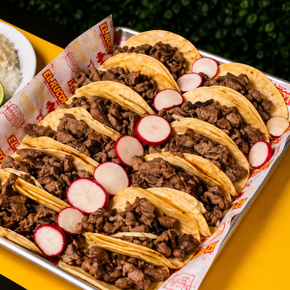 Tray of double corn tortilla tacos filled with grilled beef and garnished with sliced radishes.